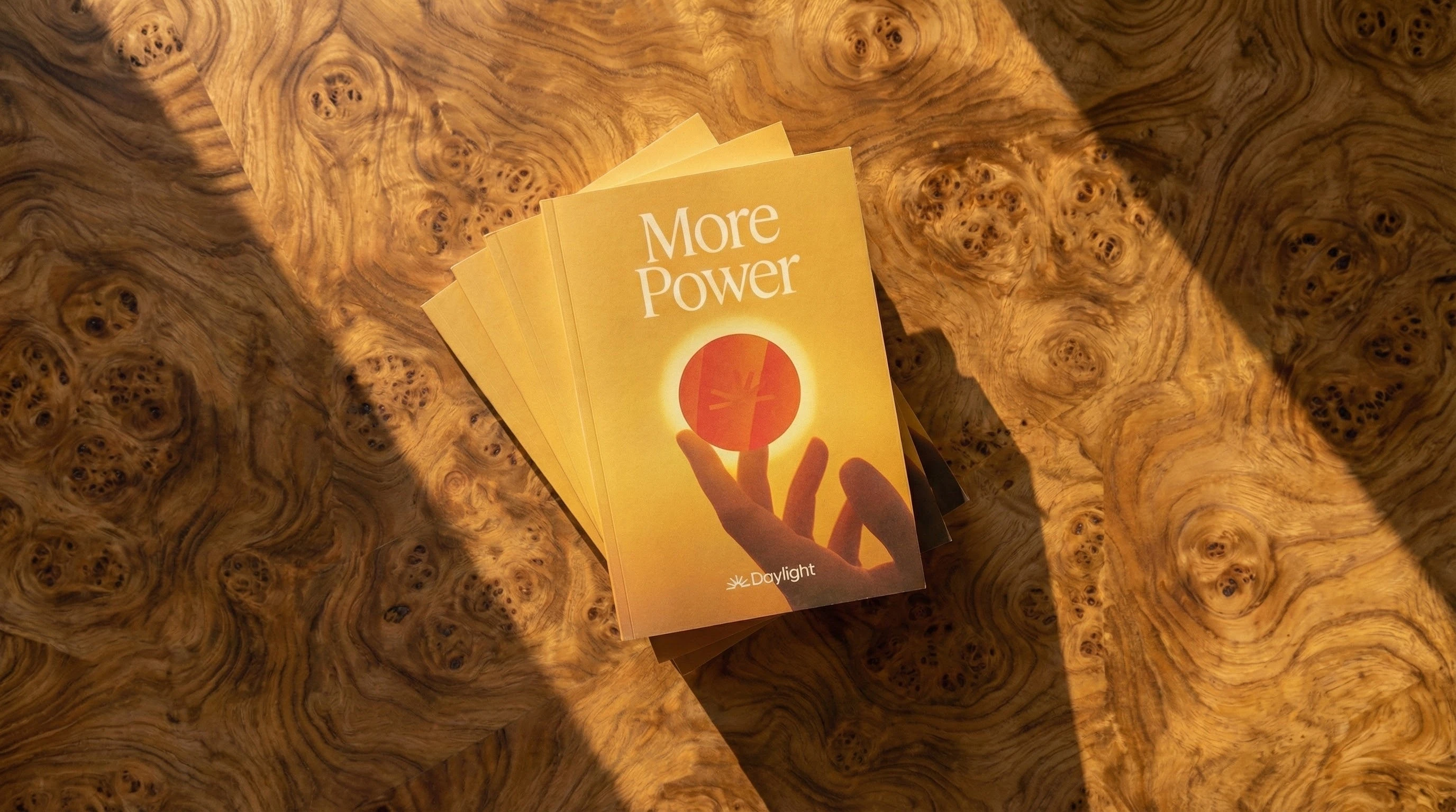 More Power booklet on a sunlit burl wood table